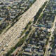 overhead view of a highway with neighborhoods on both sides