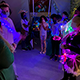 Students wearing bright lights participate in a camp activity.