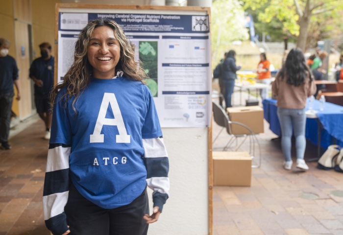 Claudia Paz Flores in front of science poster