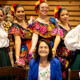 Dolores Huerta, with students in traditional Mexican folkloric dance dresses