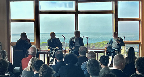 panelists, with ocean in background