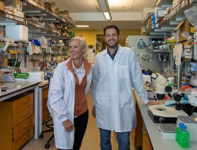 Camilla Forsberg and Bryce Manso smile in their lab space