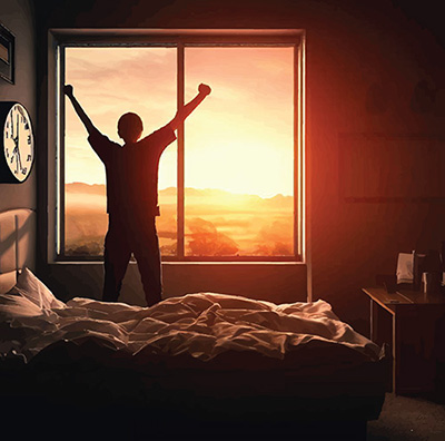 person waking as the sun rises