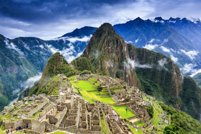 The Machu Picchu ruins from above, shrouded in clouds