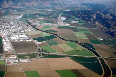 aerial view of pajaro river running through towns and agriculture fields