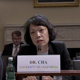 J. Mijin Cha speaking into a microphone in a congressional meeting room
