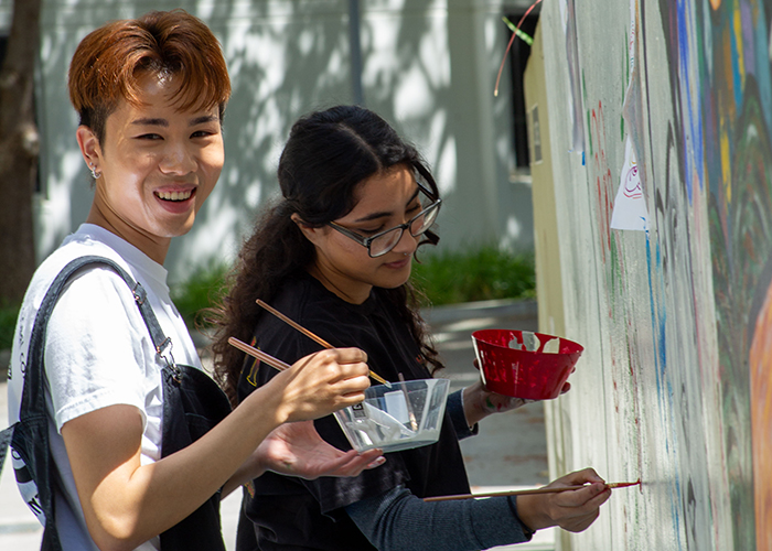 Students painting Merrill Moat mural