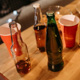 empty beer bottles and cups on a table