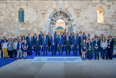 A large group of people standing in front of a stone building