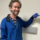 Kevin Lofgren in lab holding flask of biodiesel