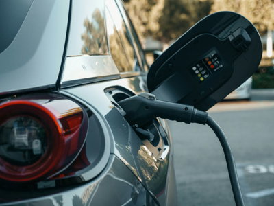 An electric car with charging cord plugged in