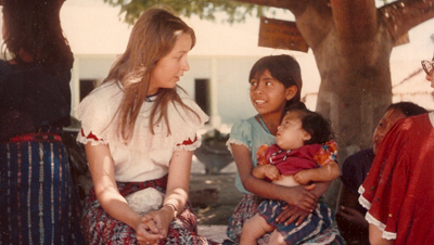 Rogoff sitting and talking with a young child and a toddler