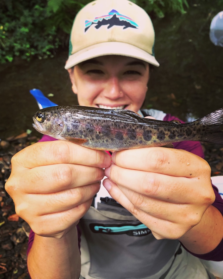 UC Santa Cruz student holding baby fish