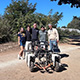 Five people stand smiling behind a robotic tractor ont he UCSC farm