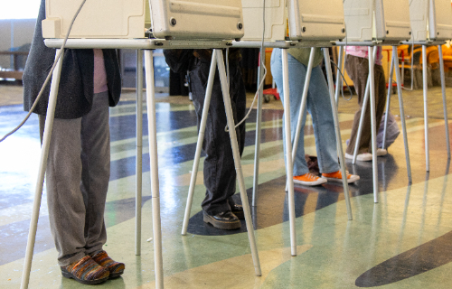 Voters mark their ballots at the main campus polling site.