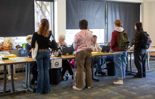 Voters get started by checking in with volunteers at Stevenson Event Center Monday morning