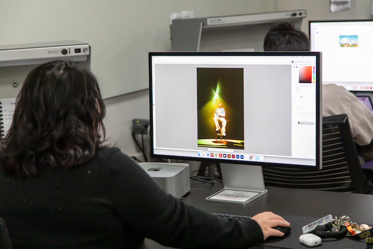 Screen printing class, student on computer