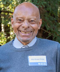 John Brown Childs in a blue sweater and blue shirt.