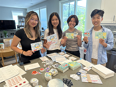 Lee with her Citro Tech team packing up Citro Hacks swag to mail out.