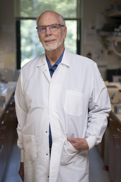 Portrait of Dave Deamer wearing a white lab coat