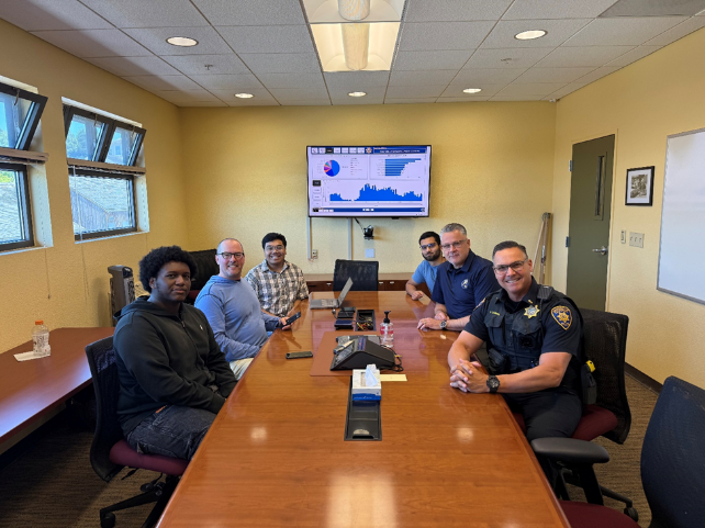 Students and officers at a conference table