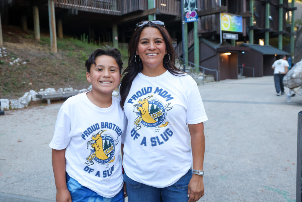 Family members wearing "proud brother of a slug" and "proud mom of a slug" t-shirts