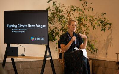 KQED science journalist Danielle Venton sitting on stage