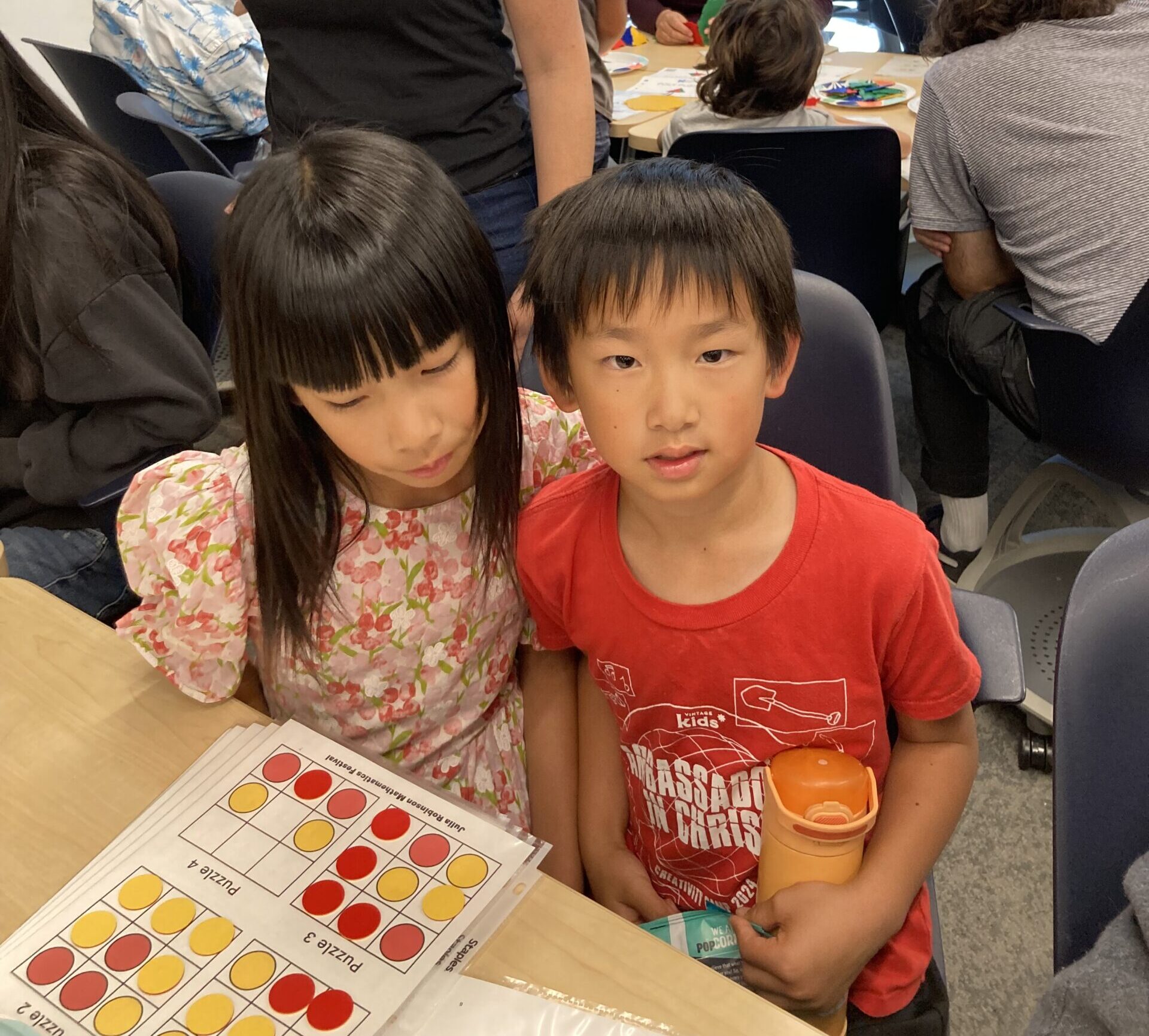 Two young children play math games