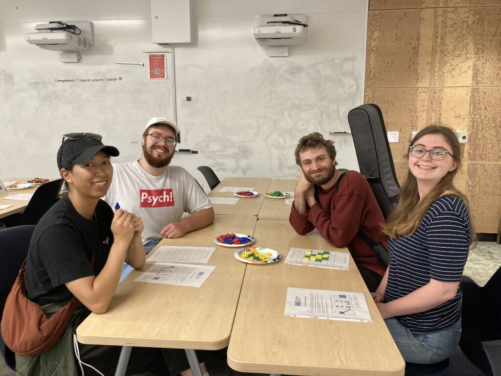 Four graduate students smile at the camera