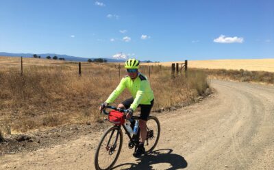 UC Santa Cruz Professor William Scott on a bike on a dirt road