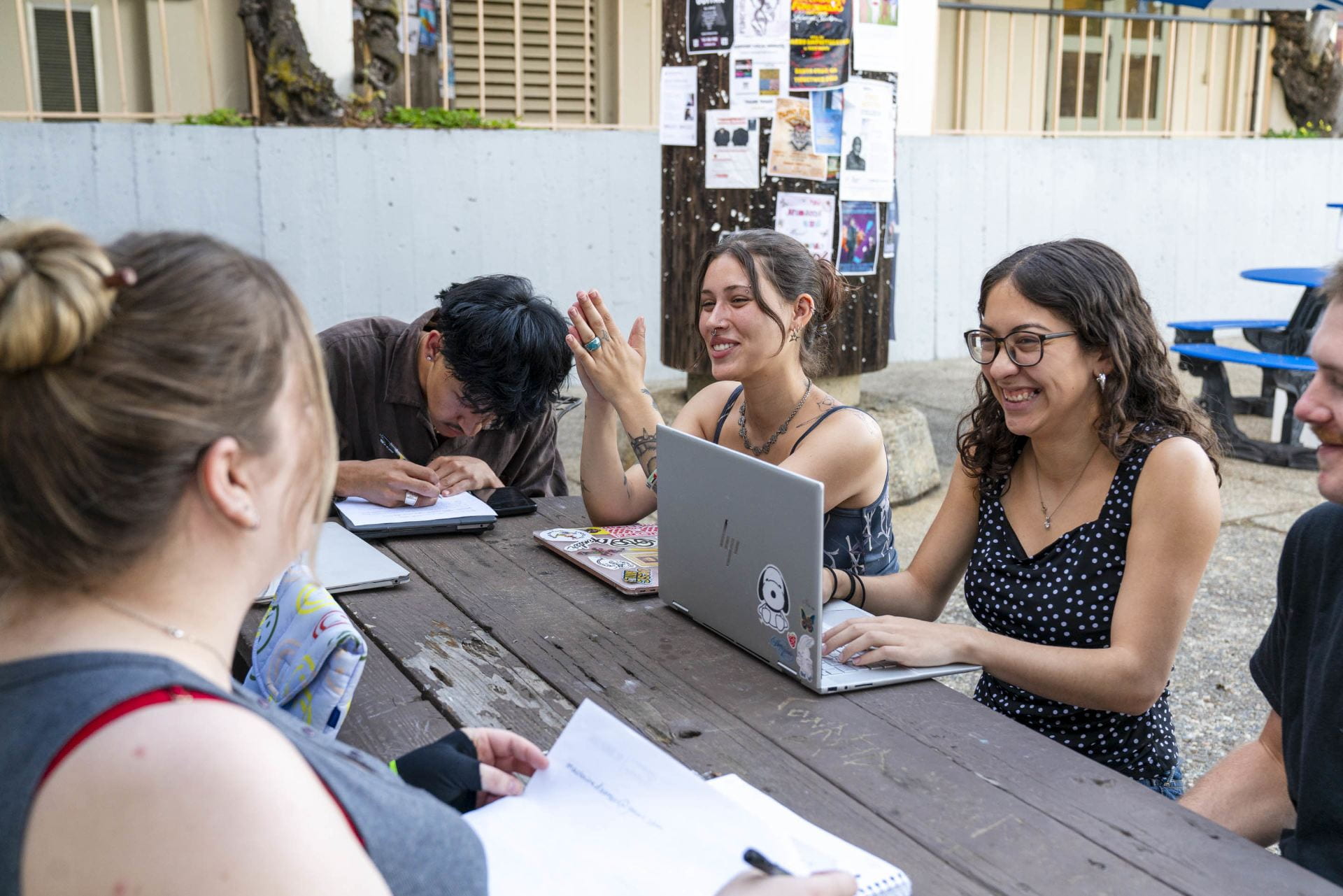 students at a table with an advisor