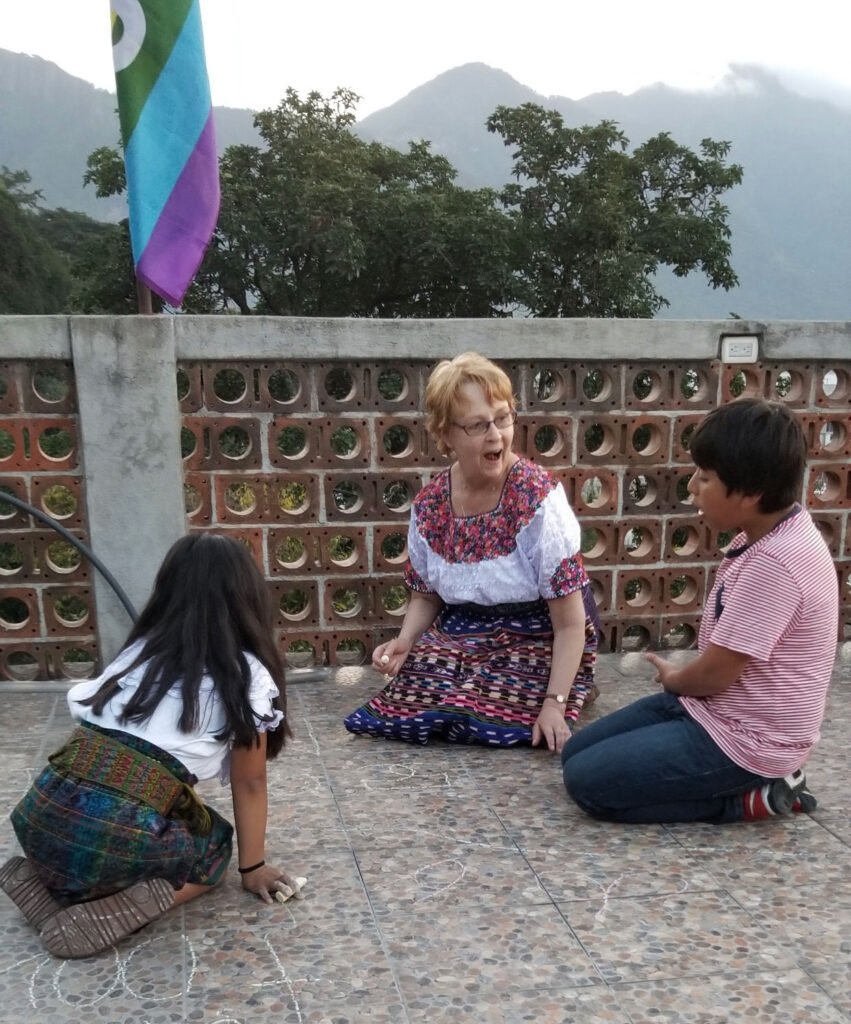 Rogoff playing game and interacting with kids. 