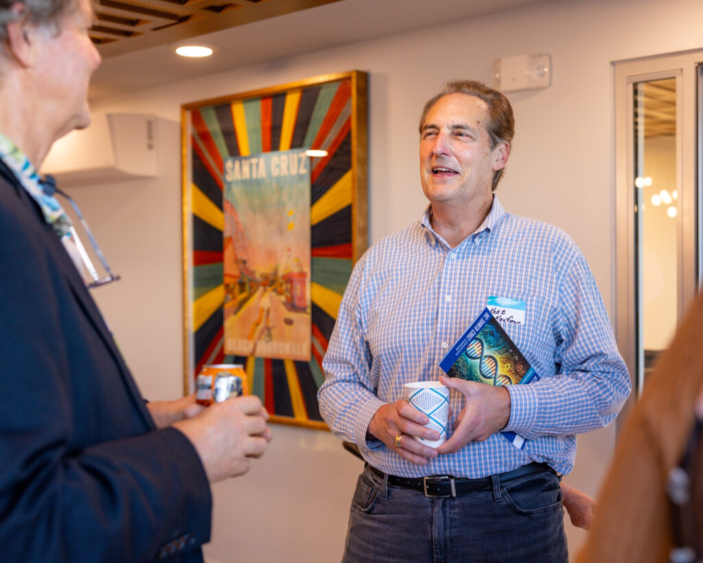 David Haussler speaks with a guest at the Mixer