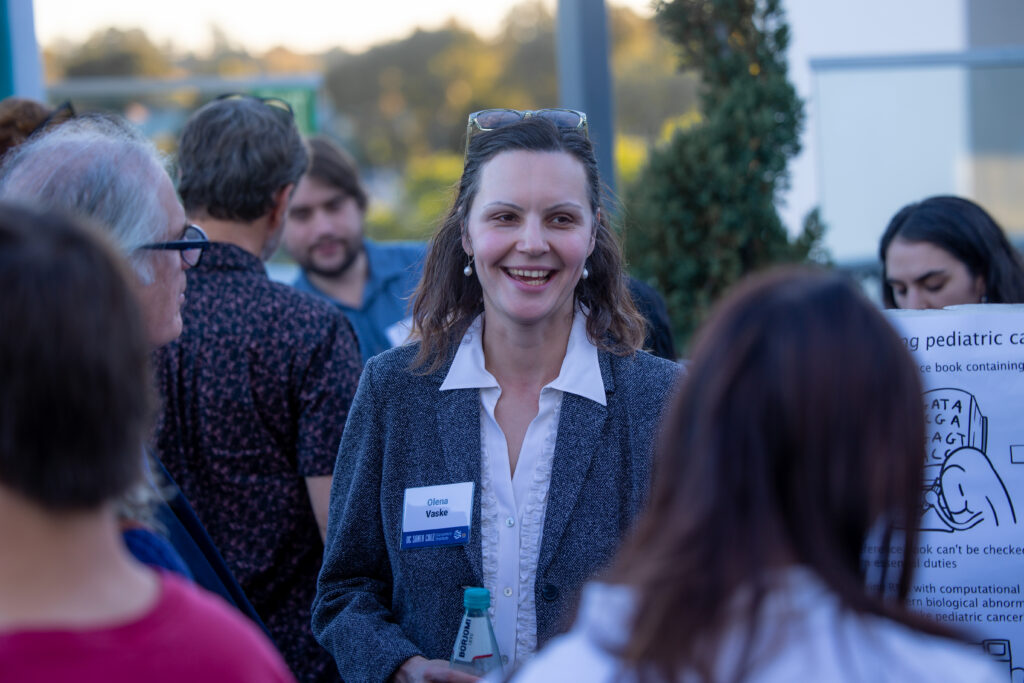 Olena Vaske in a crowd at the Genomics Institute mixer