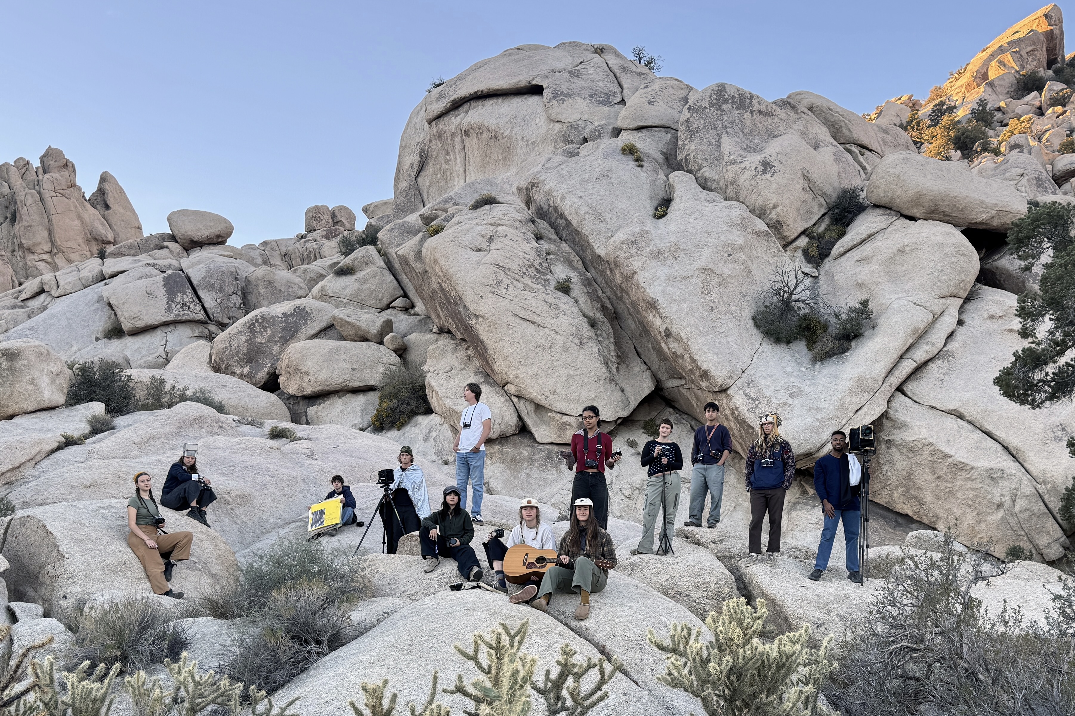 Art students standing on a mountain of boulders