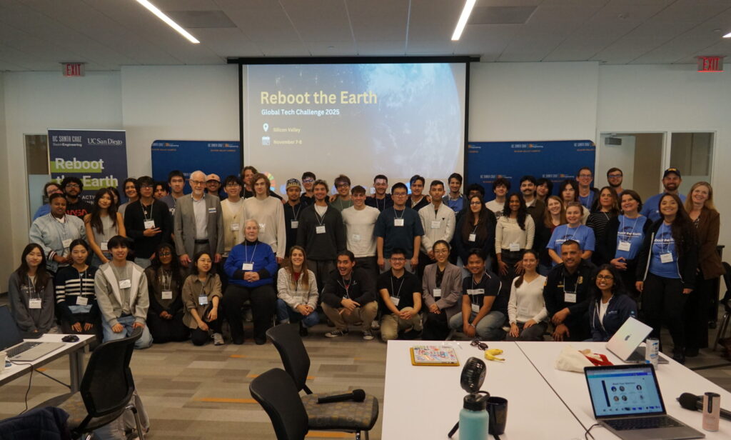 Full group of participants smile at the camera.