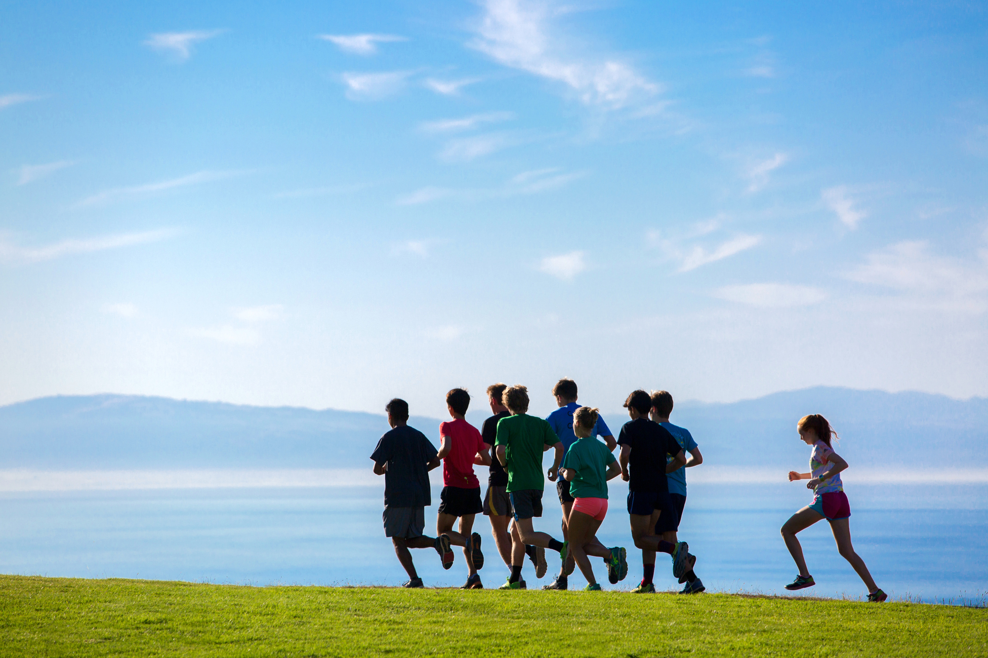 group of students running on the east field running path overlooking Monterey Bay