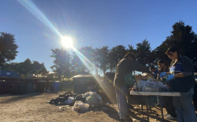 Students performing a waste audit outside.