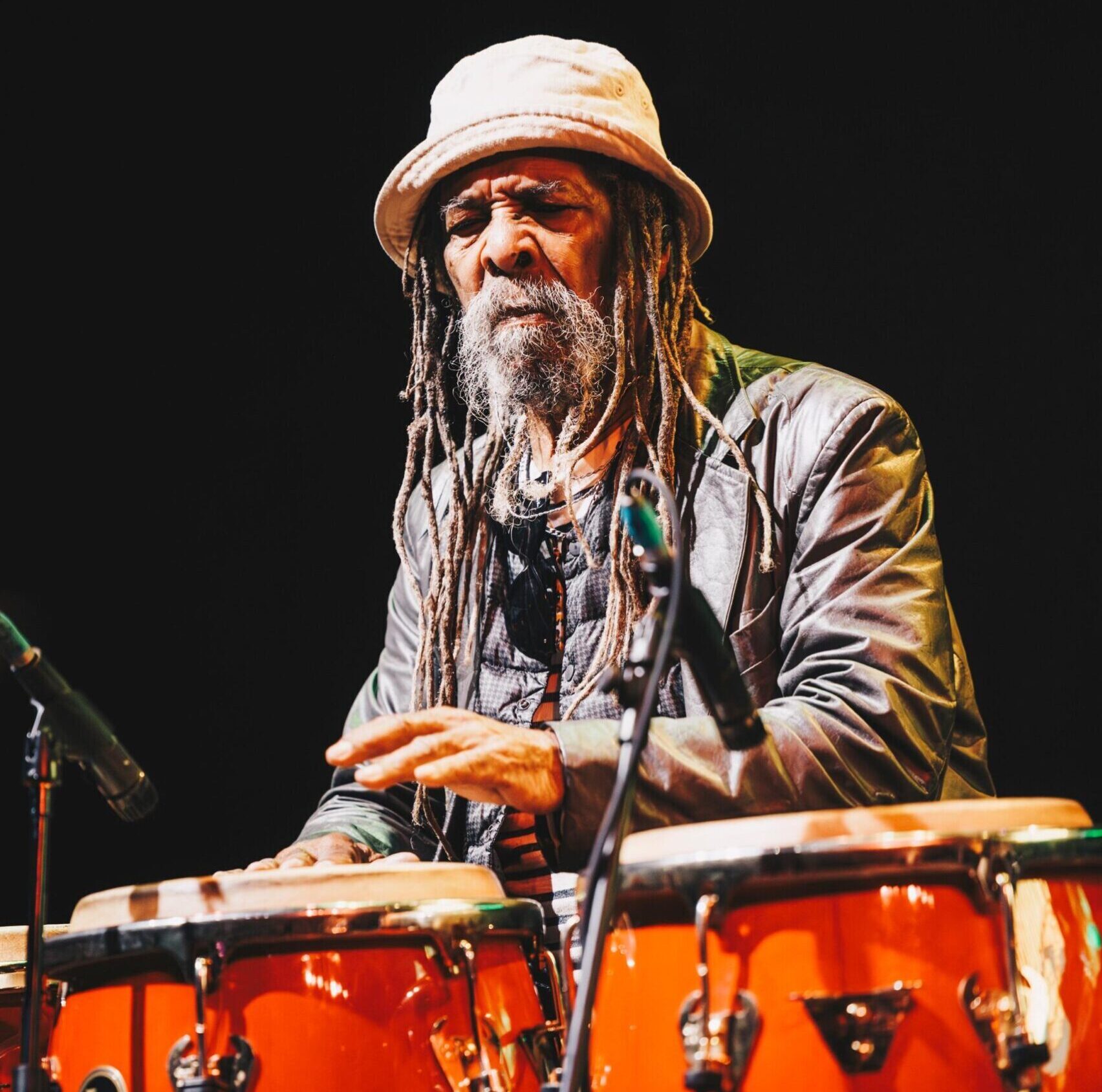 Larry McDonald playing congas during a performance