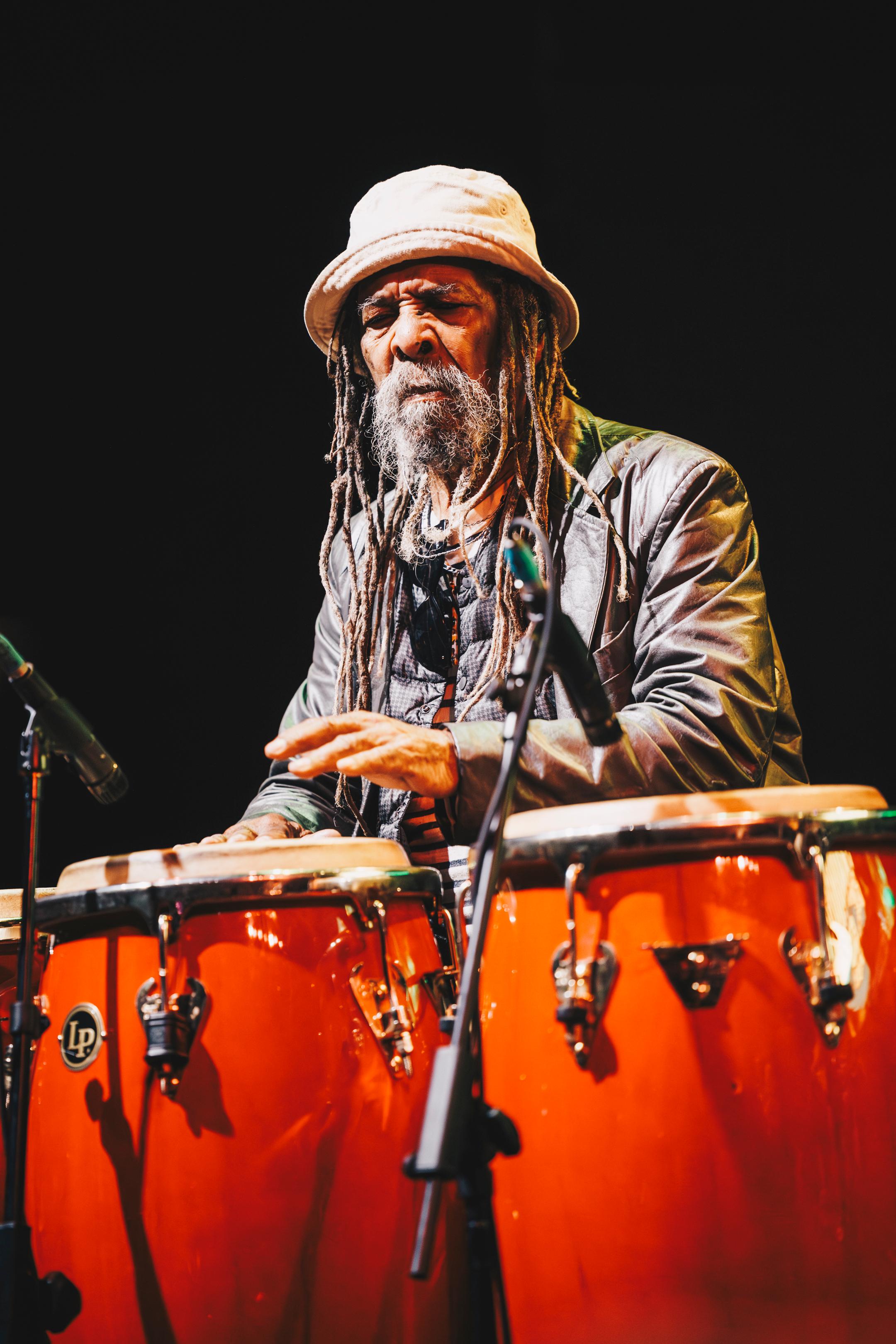 Larry McDonald playing congas during a performance