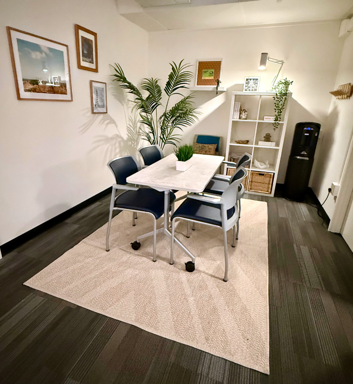 Cove creative engagement space; includes table and four chairs, water bubbler, and bookshelf