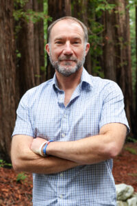 Richard E. Green outside in the in the redwoods at UC Santa Cruz.