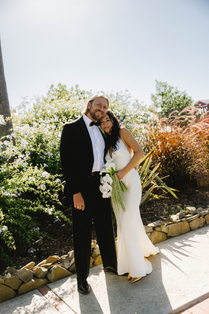 Alaleh Mokhtari and Redmond Walton pose for a photo at their wedding