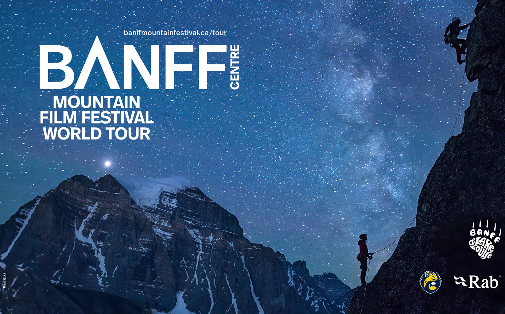 rock climbers silhouetted agains the night sky and mountains