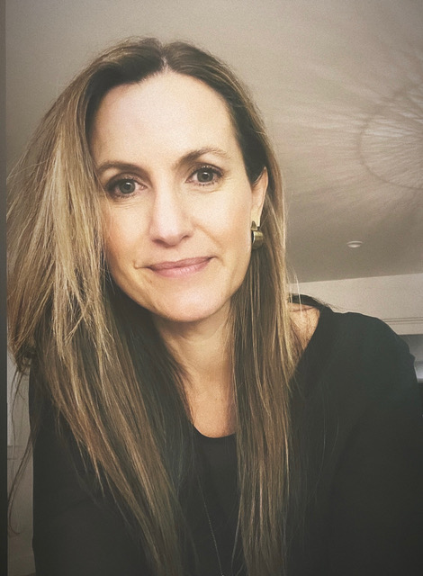 Portrait of Sarah Sanford, a woman with long hair looking at the camera