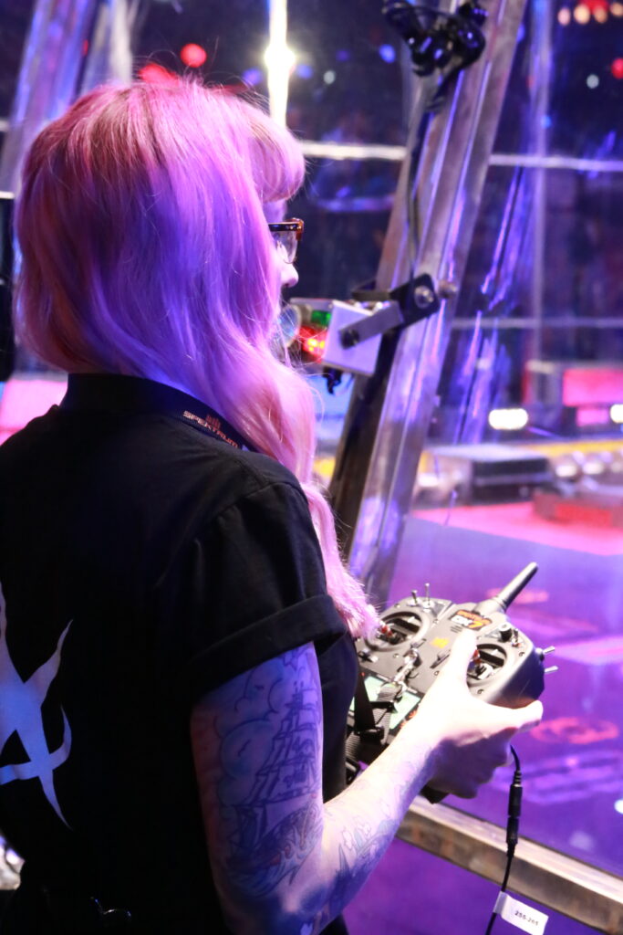 Lisa Winter holding a controller outside of an arena 
