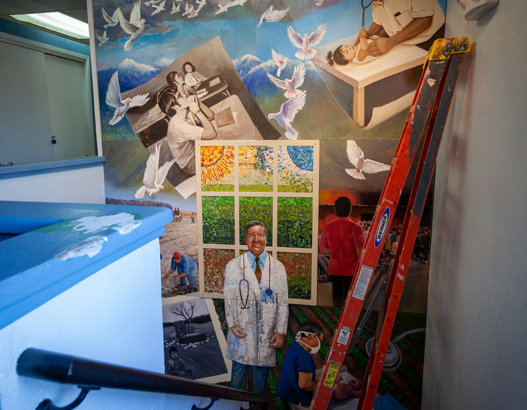 A mural of Dr. Ramon Resa on top of a flight of stairs.