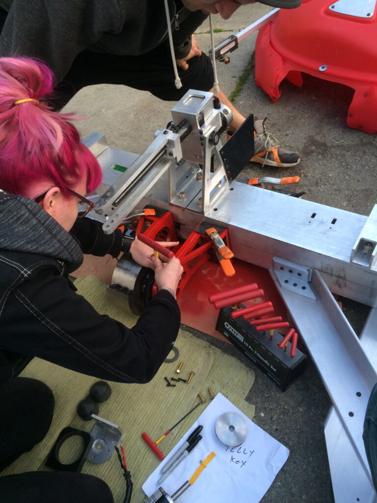 Lisa Winter works on a robot up close 