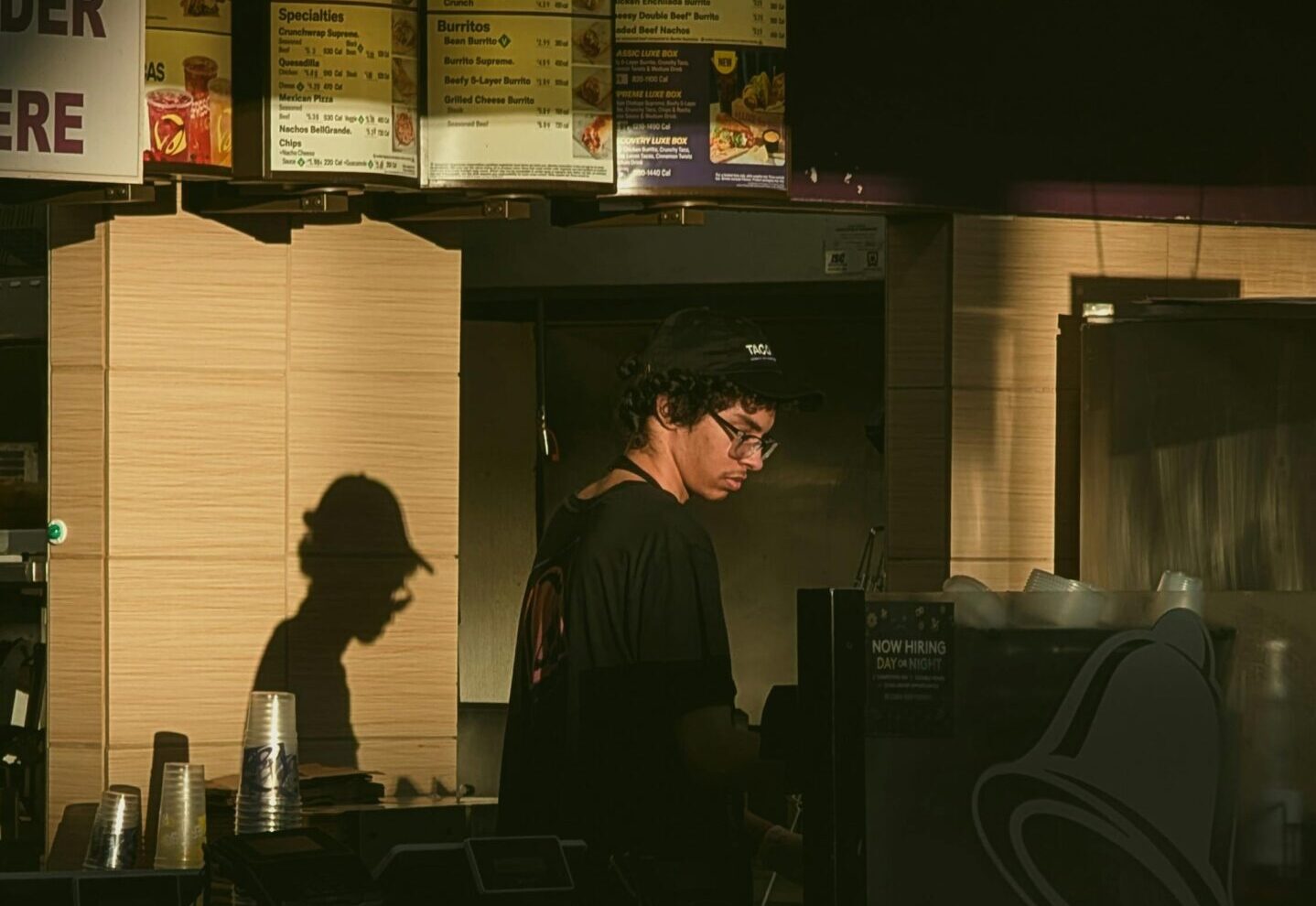 worker stands at fast food counter
