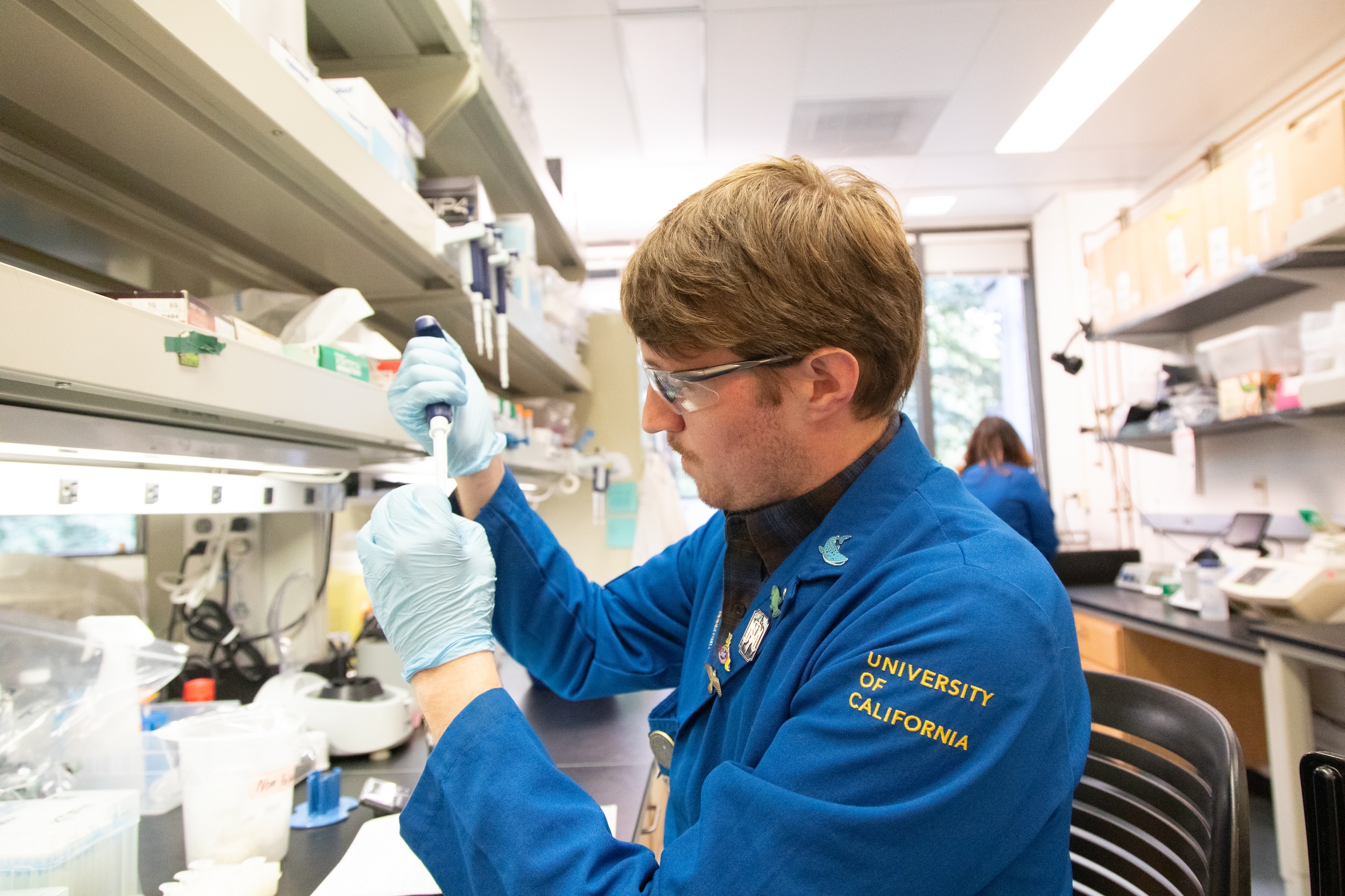 UC lab researcher handling material